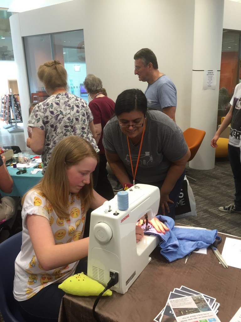 Me helping a young lady to sew her bag